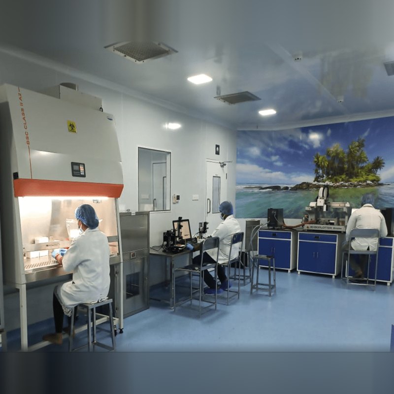 Researchers in the Bio Valley clean-room laboratory with a biosafety cabinet and 3D bioplotter